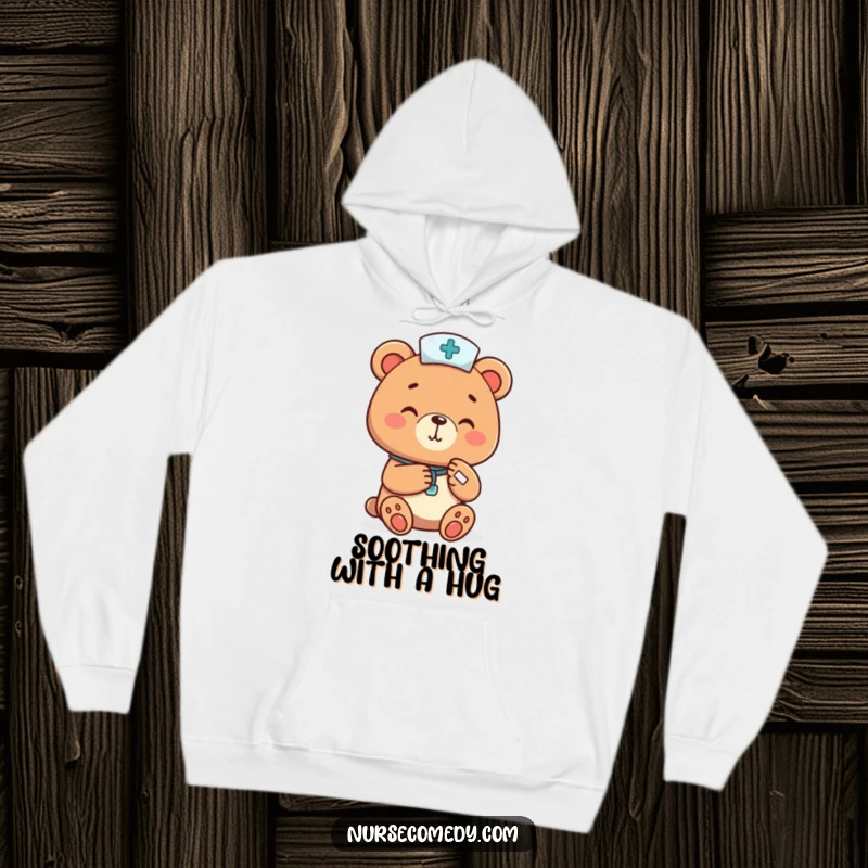 Funny bear nurse cheerfully bandaging a tiny paw, featured on a soft hoodie, offering cozy humor and a funny gift.